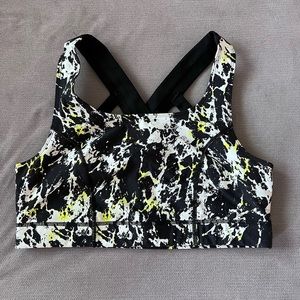 Torrid black, white, and neon yellow paint splatter sports bra